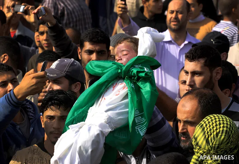 Palestinians carry the bodies of brothers Suhaib, 2-years-old, and Mohammed Hejazi, 4-years-old, during their funeral in the northern Gaza Strip area of Biet Lahia, on November 20, 2012. Four members of the Hejazi family...