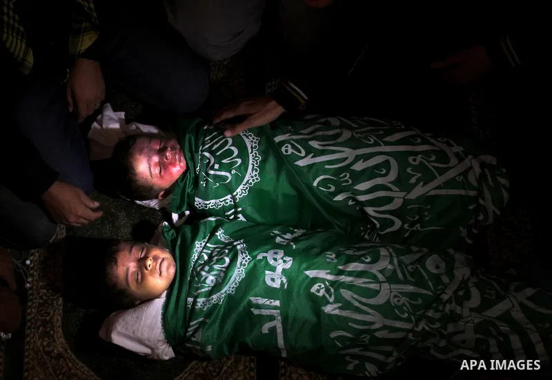 Relatives of Foud Hijazi, 45, grieves over the bodies of her son and grandsons Suhaib, 2, and Mohammed, 4, killed in an Israeli strike, during their funeral at a mosque in the Jebaliya refugee camp, in Gaza Strip, Tuesda...