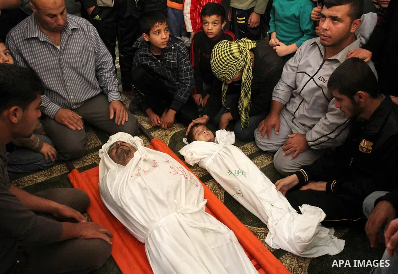 Relatives of Foud Hijazi, 45, grieves over the bodies of her son and grandsons Suhaib, 2, and Mohammed, 4, killed in an Israeli strike, during their funeral at a mosque in the Jebaliya refugee camp, in Gaza Strip, Tuesda...