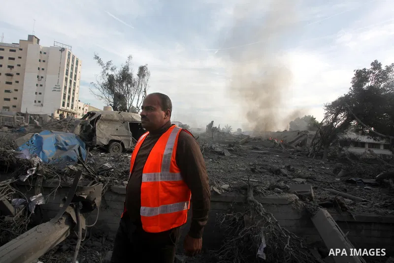 A Palestinian looks at government offices destroyed in an Israeli airstrike in Gaza City, 21 November 2012. Palestinian militants renewed their rocket fire on Israel 21 November and Israel continued pounding targets in t...