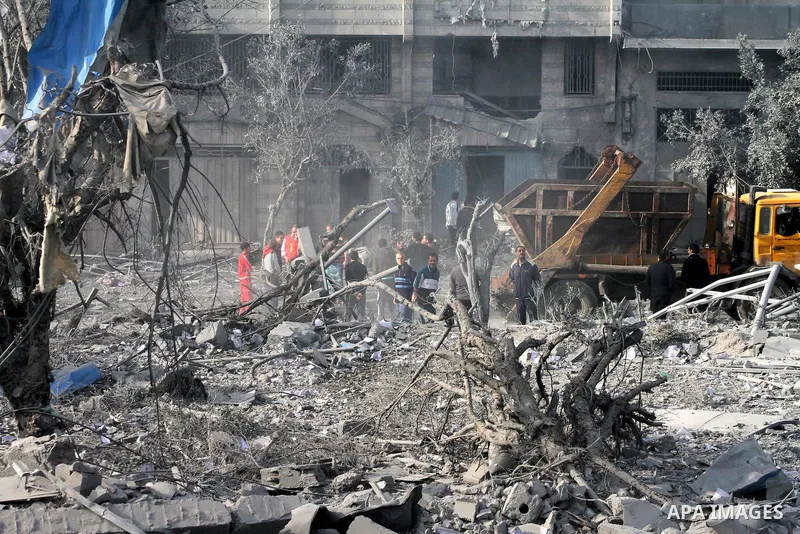 Palestinians look at government offices destroyed in an Israeli airstrike in Gaza City, 21 November 2012. Palestinian militants renewed their rocket fire on Israel 21 November and Israel continued pounding targets in the...