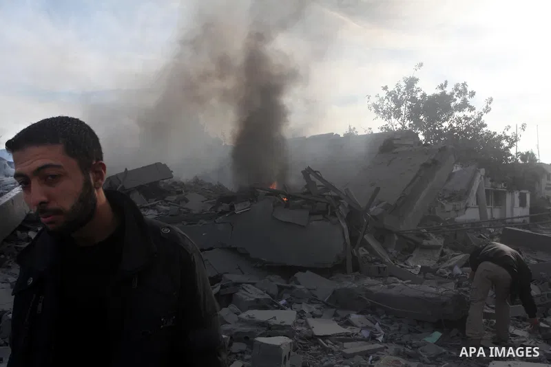 A Palestinian looks at government offices destroyed in an Israeli airstrike in Gaza City, 21 November 2012. Palestinian militants renewed their rocket fire on Israel 21 November and Israel continued pounding targets in t...