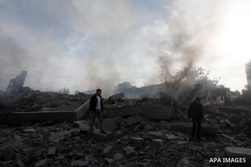 Palestinians look at government offices destroyed in an Israeli airstrike in Gaza City, 21 November 2012. Palestinian militants renewed their rocket fire on Israel 21 November and Israel continued pounding targets in the...