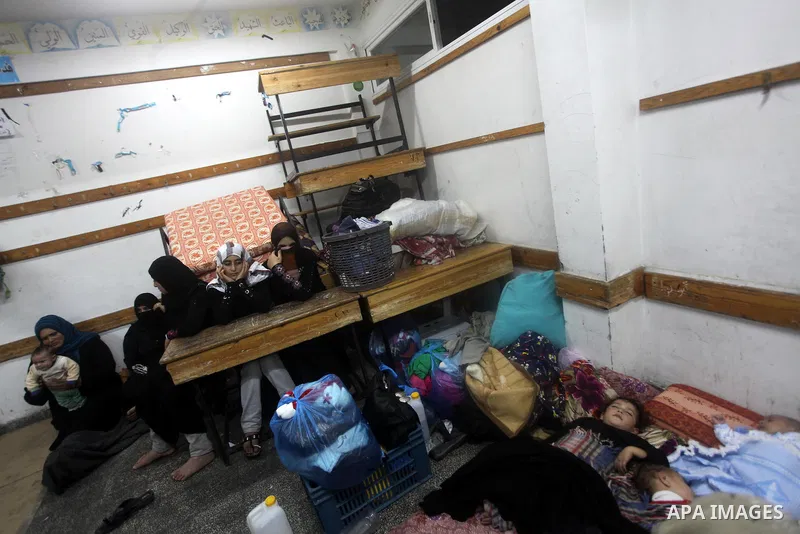 Displaced Palestinians from al-Atatra area, whose fled their house, gather in their temporary residence, at a United Nations-run school in Gaza City, on November 21, 2012. Israeli leaders discussed an Egyptian plan for a...