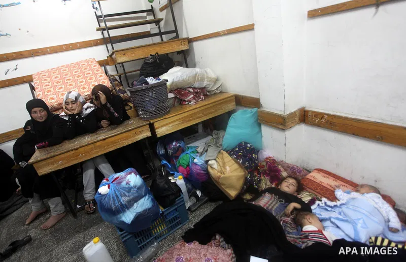 Displaced Palestinians from al-Atatra area, whose fled their house, gather in their temporary residence, at a United Nations-run school in Gaza City, on November 21, 2012. Israeli leaders discussed an Egyptian plan for a...
