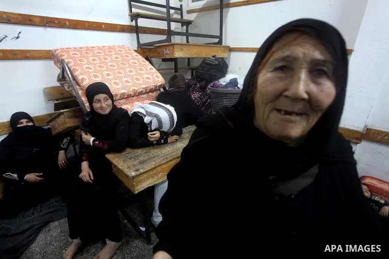 Displaced Palestinians from al-Atatra area, whose fled their house, gather in their temporary residence, at a United Nations-run school in Gaza City, on November 21, 2012. Israeli leaders discussed an Egyptian plan for a...