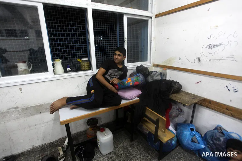Displaced Palestinians from al-Atatra area, whose fled their house, gather in their temporary residence, at a United Nations-run school in Gaza City, on November 21, 2012. Israeli leaders discussed an Egyptian plan for a...