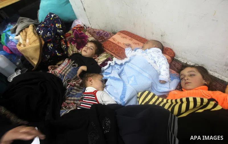 Displaced Palestinians from al-Atatra area, whose fled their house, gather in their temporary residence, at a United Nations-run school in Gaza City, on November 21, 2012. Israeli leaders discussed an Egyptian plan for a...