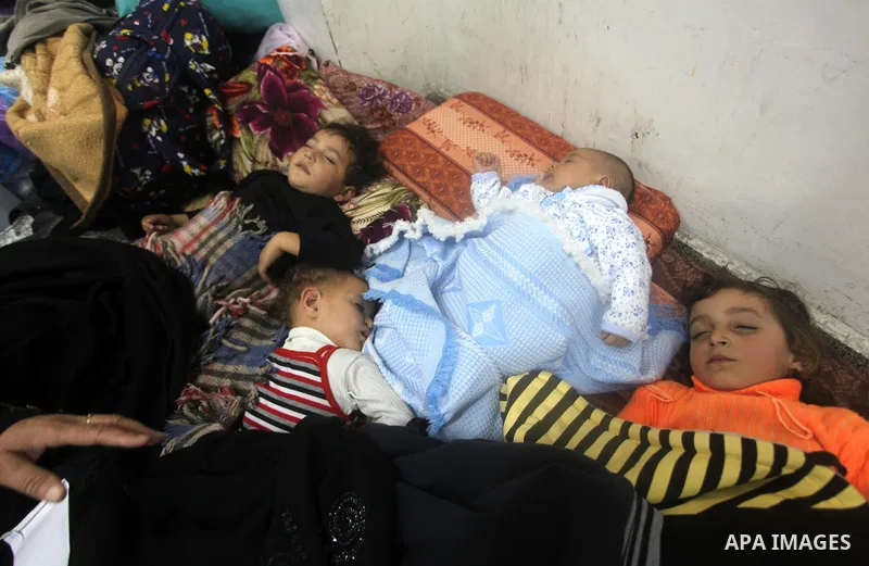 Displaced Palestinians from al-Atatra area, whose fled their house, gather in their temporary residence, at a United Nations-run school in Gaza City, on November 21, 2012. Israeli leaders discussed an Egyptian plan for a...