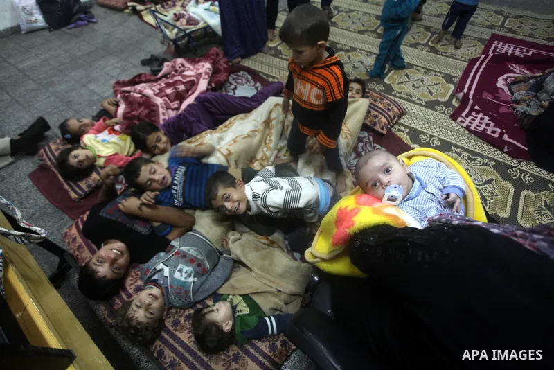 Displaced Palestinians from al-Atatra area, whose fled their house, gather in their temporary residence, at a United Nations-run school in Gaza City, on November 21, 2012. Israeli leaders discussed an Egyptian plan for a...