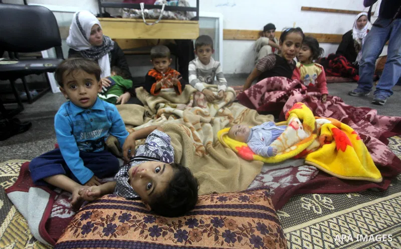 Displaced Palestinians from al-Atatra area, whose fled their house, gather in their temporary residence, at a United Nations-run school in Gaza City, on November 21, 2012. Israeli leaders discussed an Egyptian plan for a...