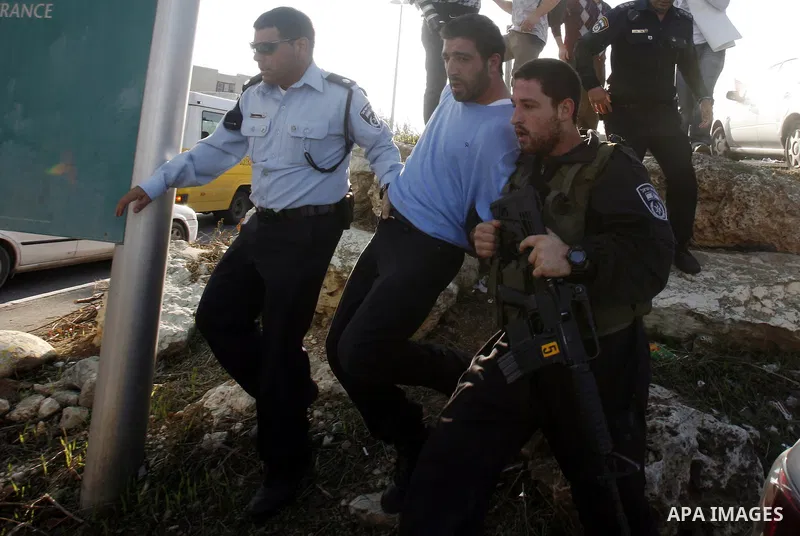 Israeli soldiers arrest a Palestinian protester during a Palestinian protest at Hebrew University in Jerusalem, 20 November 2012, showing solidarity with the Palestinians in the Gaza Strip, as hostilities continue on the...