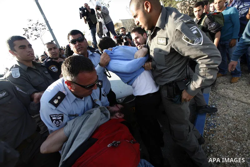 Israeli soldiers arrest a Palestinian protester during a Palestinian protest at Hebrew University in Jerusalem, 20 November 2012, showing solidarity with the Palestinians in the Gaza Strip, as hostilities continue on the...