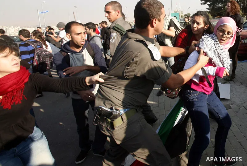 Palestinian protestors and Israelis shout slogans during a protest in Hebrew University in Jerusalem's Old City 20 November 2012, showing solidarity with the Palestinians in the Gaza Strip, as hostilities continue on the...
