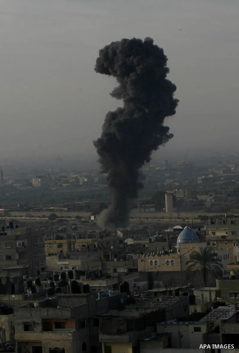 Smoke rises following an Israeli strike on smuggling tunnels along the border between Egypt and Rafah southern Gaza Strip, Wednesday, Nov. 21, 2012. Israeli aircraft pounded Gaza with at least 30 strikes overnight, hitti...