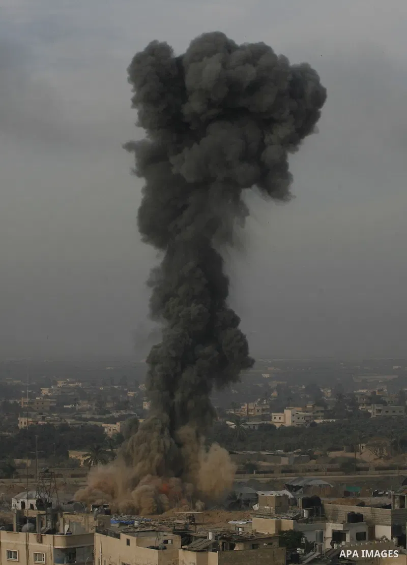 Smoke rises following an Israeli strike on smuggling tunnels along the border between Egypt and Rafah southern Gaza Strip, Wednesday, Nov. 21, 2012. Israeli aircraft pounded Gaza with at least 30 strikes overnight, hitti...