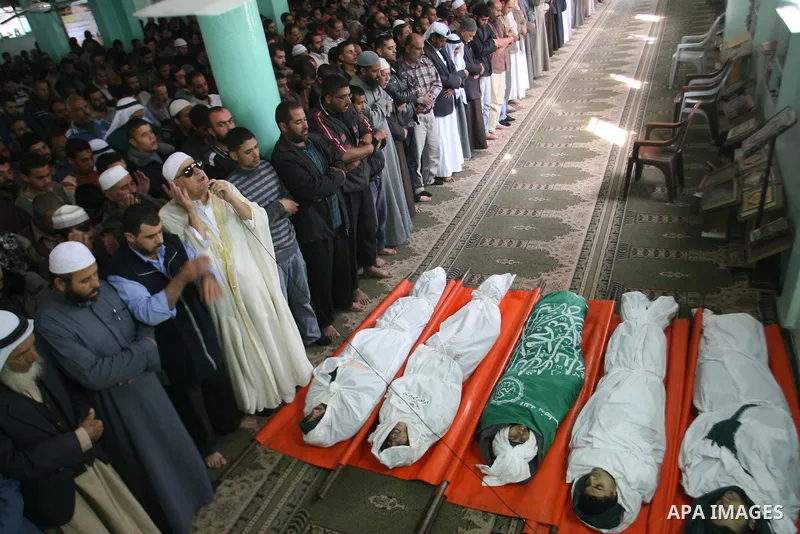 Palestinian mourners pray over the bodies of five Palestinians killed in Israeli strikes during their funeral in Rafah, southern Gaza Strip, Wednesday, Nov. 21, 2012. U.S. Secretary of State Hillary Rodham Clinton shuttl...
