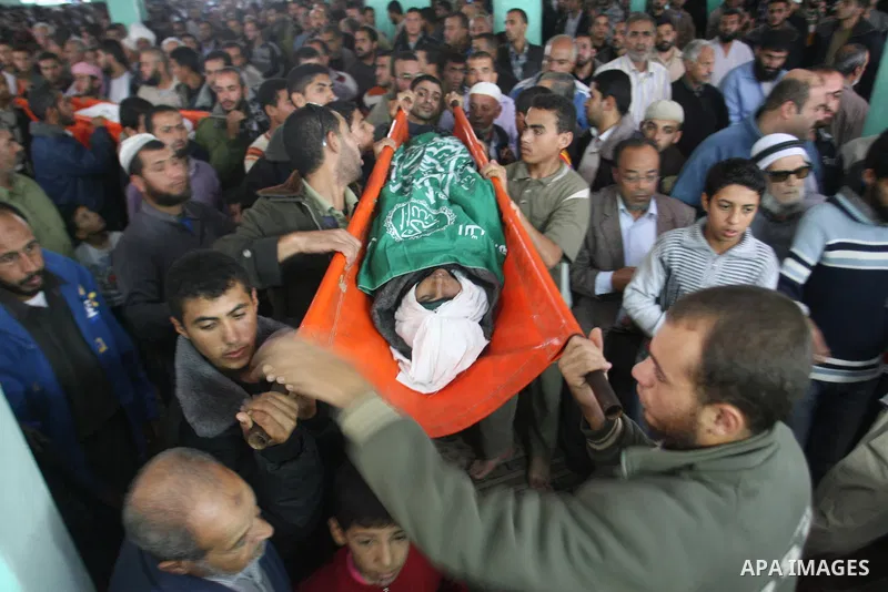 Palestinian mourners carry the bodies of five Palestinians killed in Israeli strikes during their funeral in Rafah, southern Gaza Strip, Wednesday, Nov. 21, 2012. U.S. Secretary of State Hillary Rodham Clinton shuttled b...
