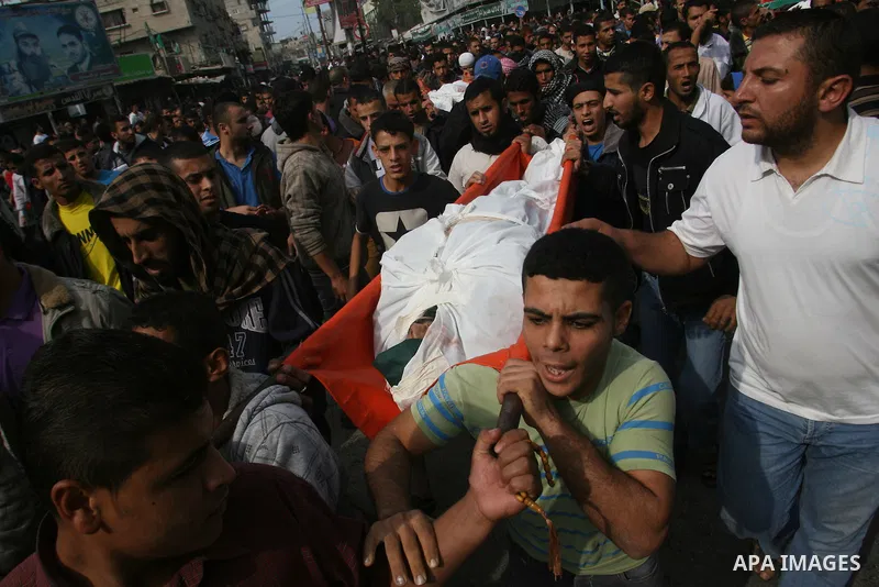 Palestinian mourners carry the bodies of five Palestinians killed in Israeli strikes during their funeral in Rafah, southern Gaza Strip, Wednesday, Nov. 21, 2012. U.S. Secretary of State Hillary Rodham Clinton shuttled b...