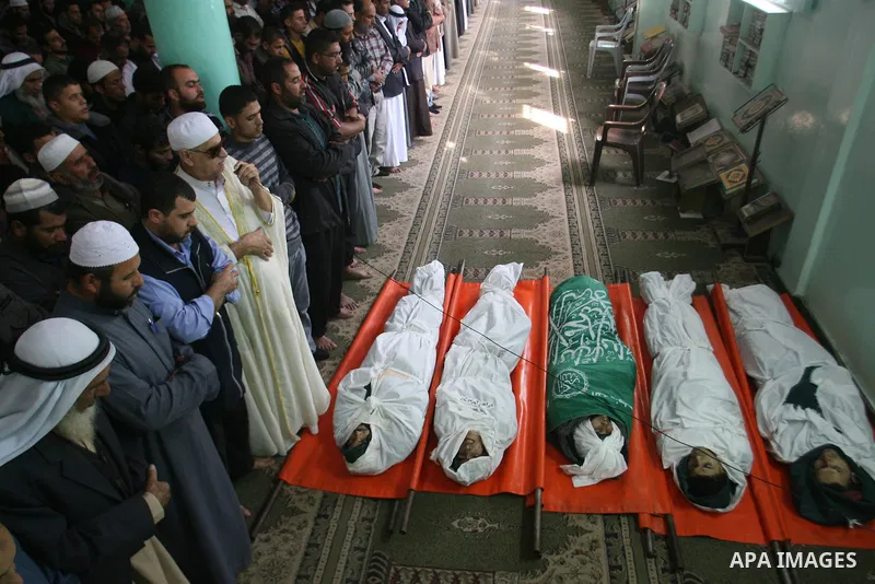 Palestinian mourners pray over the bodies of five Palestinians killed in Israeli strikes during their funeral in Rafah, southern Gaza Strip, Wednesday, Nov. 21, 2012. U.S. Secretary of State Hillary Rodham Clinton shuttl...