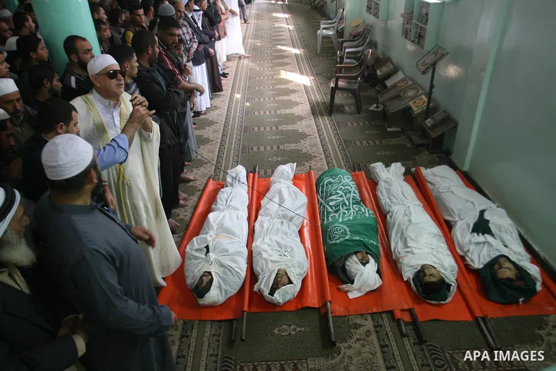 Palestinian mourners pray over the bodies of five Palestinians killed in Israeli strikes during their funeral in Rafah, southern Gaza Strip, Wednesday, Nov. 21, 2012. U.S. Secretary of State Hillary Rodham Clinton shuttl...