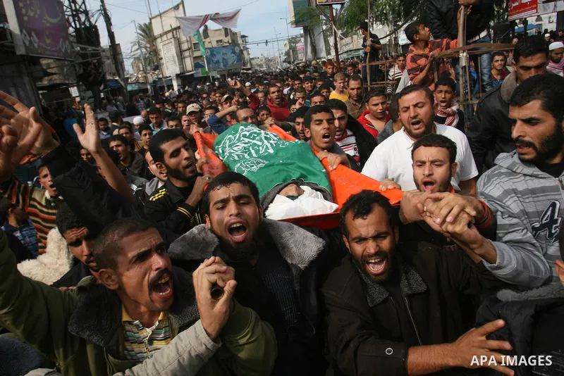 Palestinian mourners carry the bodies of five Palestinians killed in Israeli strikes during their funeral in Rafah, southern Gaza Strip, Wednesday, Nov. 21, 2012. U.S. Secretary of State Hillary Rodham Clinton shuttled b...