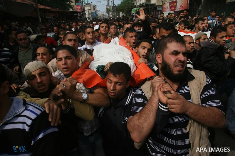 Palestinian mourners carry the bodies of five Palestinians killed in Israeli strikes during their funeral in Rafah, southern Gaza Strip, Wednesday, Nov. 21, 2012. U.S. Secretary of State Hillary Rodham Clinton shuttled b...