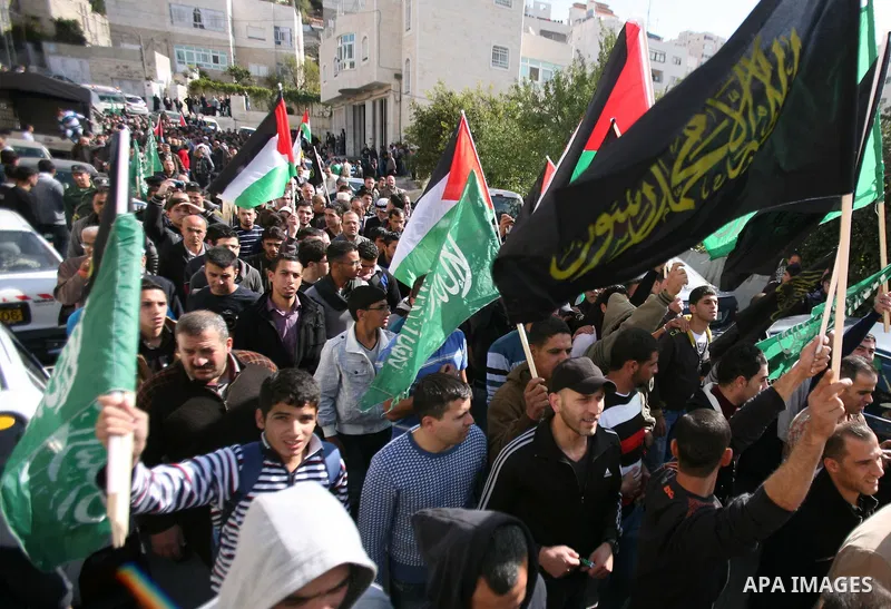 Relatives of Hamdi al Fallah touch his body during his funeral in the West Bank city of Hebron November 20, 2012. Two funeral processions for Palestinians killed during clashes with the Israeli army turned violent on Tue...