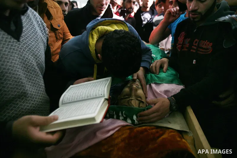 Relatives of Hamdi al Fallah touch his body during his funeral in the West Bank city of Hebron November 20, 2012. Two funeral processions for Palestinians killed during clashes with the Israeli army turned violent on Tue...
