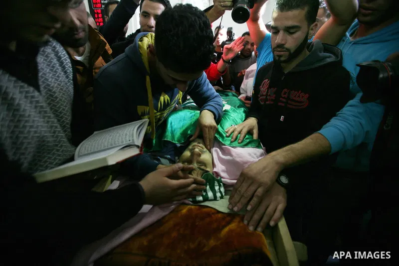 Relatives of Hamdi al Fallah touch his body during his funeral in the West Bank city of Hebron November 20, 2012. Two funeral processions for Palestinians killed during clashes with the Israeli army turned violent on Tue...