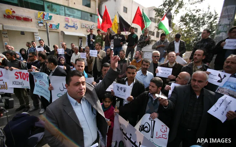 Palestinian Journalists hold placards during a protest against the Israeli targeting the Gazans media members, in the West Bank city of Hebron, November 21, 2012. Two cameramen from Hamas-owned Al-Aqsa TV were among six...