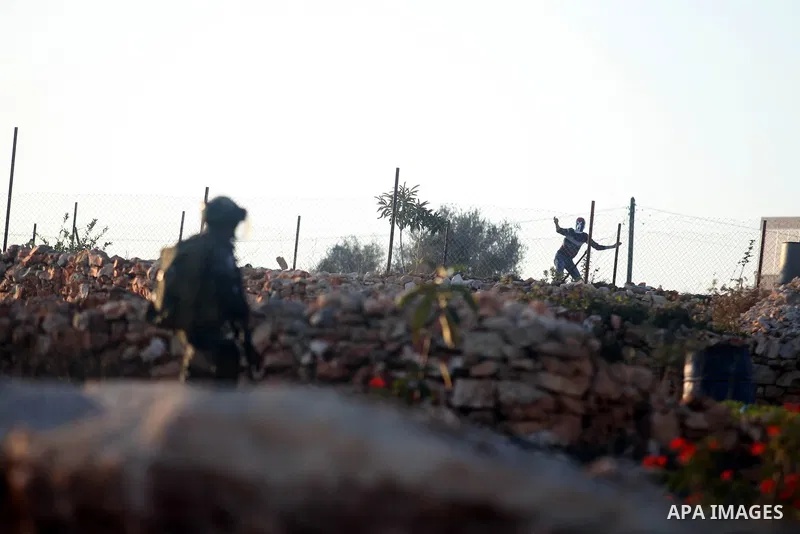Palestinian protester throw stones at Israeli security forces during clashes in the West Bank village in Nabi Saleh, near Ramallah November 20, 2012. Two funeral processions for Palestinians killed during clashes with th...