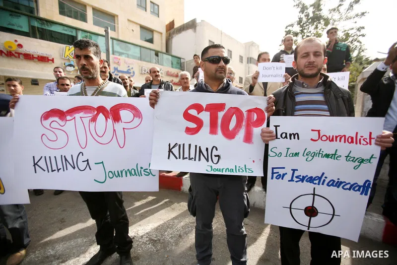 Palestinian Journalists hold placards during a protest against the Israeli targeting the Gazans media members, in the West Bank city of Hebron, November 21, 2012. Two cameramen from Hamas-owned Al-Aqsa TV were among six...