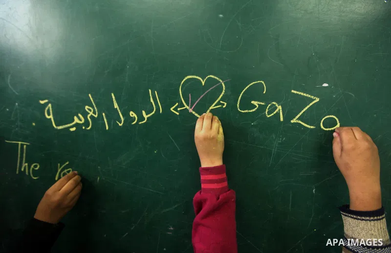 Palestinians gather where displaced families are staying after evacuating their homes earlier this week to take shelter at a United Nations (UN) school in Gaza City on November 21, 2012. Palestinian president Mahmud Abba...