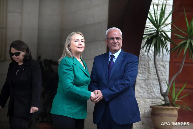 U.S. Secretary of State Hillary Clinton (L) shakes hands with chief Palestinian negotiator Saeb Erekat before her meeting with President Mahmoud Abbas (not pictured) in the West Bank city of Ramallah November 21, 2012. I...