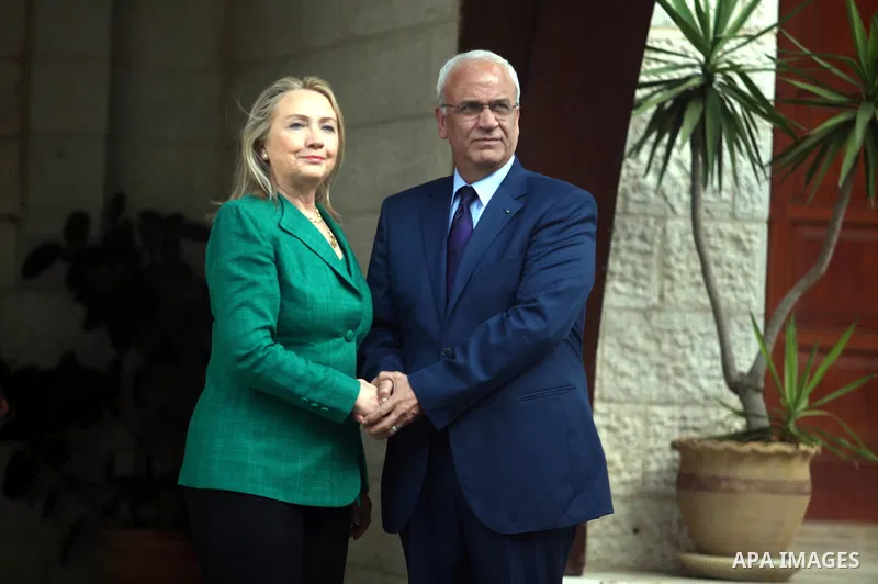 U.S. Secretary of State Hillary Clinton (L) shakes hands with chief Palestinian negotiator Saeb Erekat before her meeting with President Mahmoud Abbas (not pictured) in the West Bank city of Ramallah November 21, 2012. I...
