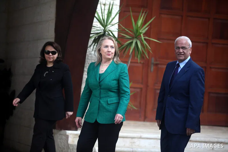U.S. Secretary of State Hillary Clinton (L) shakes hands with chief Palestinian negotiator Saeb Erekat before her meeting with President Mahmoud Abbas (not pictured) in the West Bank city of Ramallah November 21, 2012. I...
