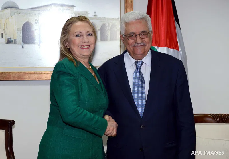 U.S. Secretary of State Hillary Rodham Clinton, left, shakes hands with Palestinian President Mahmoud Abbas during a meeting in the West Bank city of Ramallah, Wednesday, Nov. 21, 2012. Clinton will try on Wednesday to w...