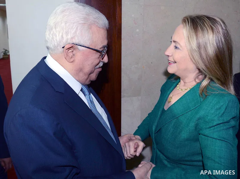 U.S. Secretary of State Hillary Rodham Clinton, left, shakes hands with Palestinian President Mahmoud Abbas during a meeting in the West Bank city of Ramallah, Wednesday, Nov. 21, 2012. Clinton will try on Wednesday to w...