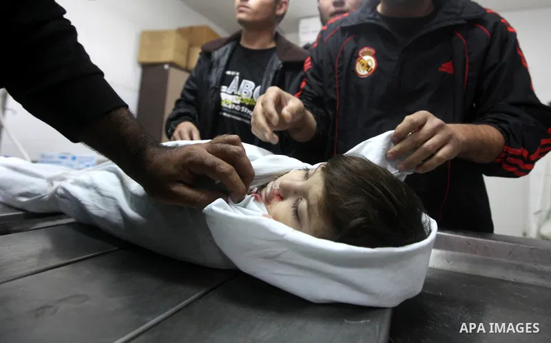 Palestinians carry the body of two years-old Abdel Rahman Majdi Naim, after he was killed in an Israeli strike in Gaza City on November 21, 2012. Naim was killed in a second Israeli strike on the building housing AFP'S G...