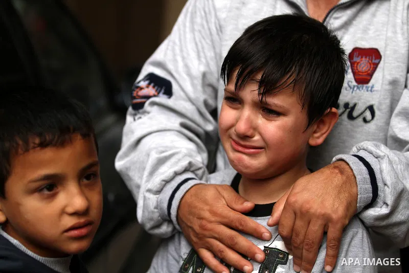 The brother of two-year-old Abdel Rahman Majdi Naim, was killed in an Israeli strike, mourns in Gaza City on November 21, 2012. Naim was killed in a second Israeli strike on the building housing AFP'S Gaza offices, Hamas...