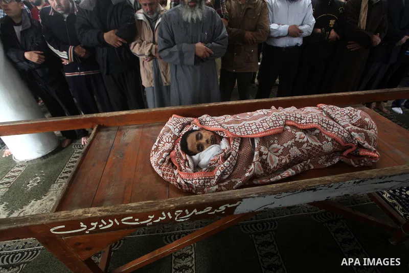 Palestinian mourners pray around the body of Mohammed Ashour, 10, killed the previous day in an Israeli air strike on Gaza City, during his funeral, Wednesday, Nov. 21, 2012. Israeli aircraft pounded Gaza with at least 3...