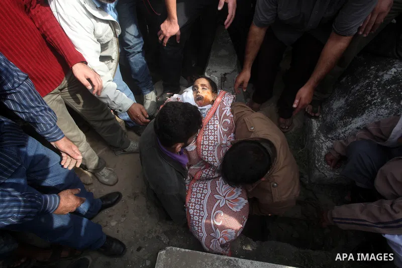 A Palestinian man carries the body of Mohammed Ashour, 10, killed the previous day in an Israeli air strike on Gaza City, during his funeral, Wednesday, Nov. 21, 2012. Israeli aircraft pounded Gaza with at least 30 strik...