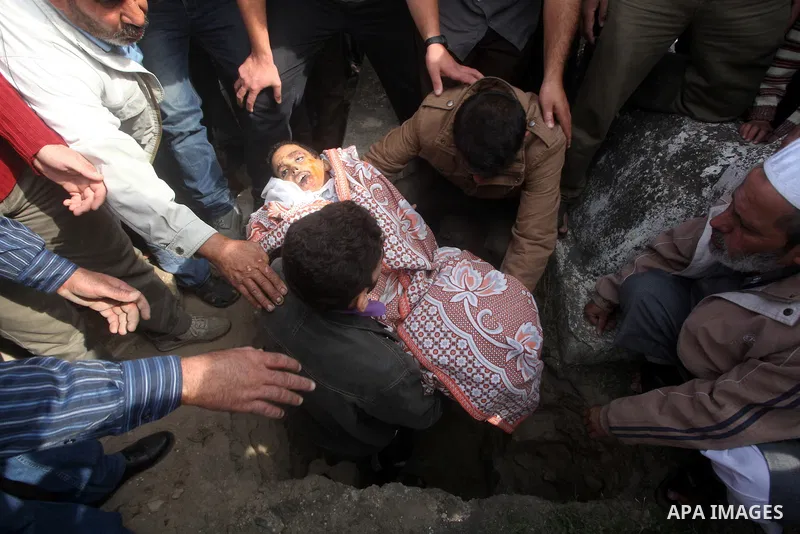 A Palestinian man carries the body of Mohammed Ashour, 10, killed the previous day in an Israeli air strike on Gaza City, during his funeral, Wednesday, Nov. 21, 2012. Israeli aircraft pounded Gaza with at least 30 strik...