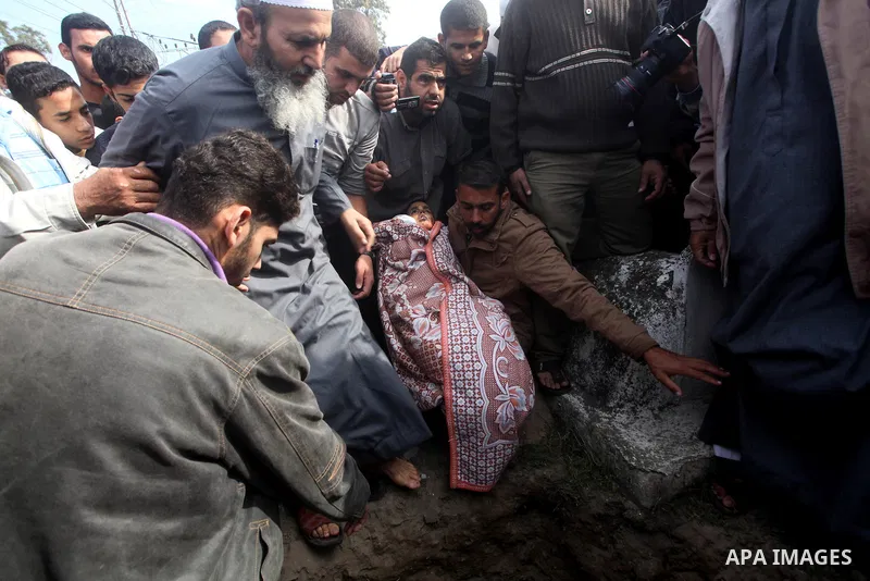 A Palestinian man carries the body of Mohammed Ashour, 10, killed the previous day in an Israeli air strike on Gaza City, during his funeral, Wednesday, Nov. 21, 2012. Israeli aircraft pounded Gaza with at least 30 strik...