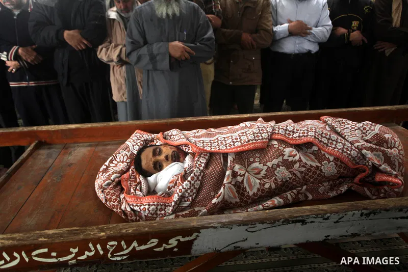 Palestinian mourners pray around the body of Mohammed Ashour, 10, killed the previous day in an Israeli air strike on Gaza City, during his funeral, Wednesday, Nov. 21, 2012. Israeli aircraft pounded Gaza with at least 3...