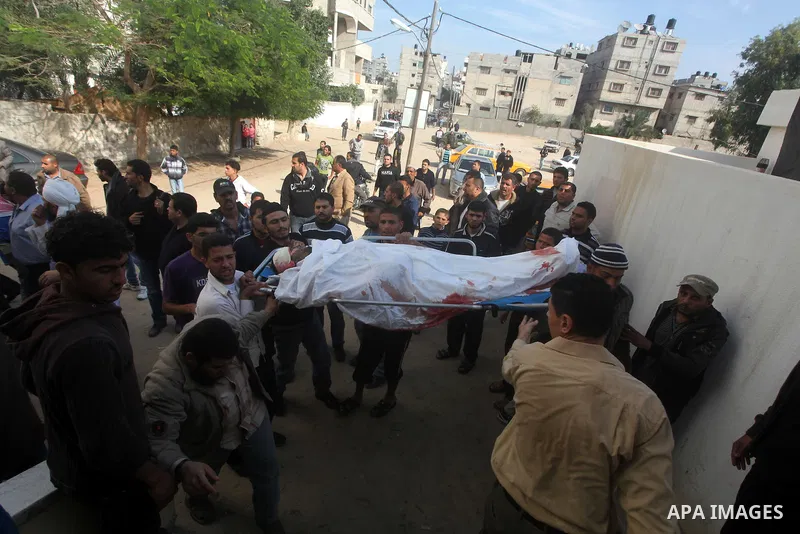 Palestinians carry the body of Mohammed Ashour, 10, killed the previous day in an Israeli air strike on Gaza City, during his funeral, Wednesday, Nov. 21, 2012. Israeli aircraft pounded Gaza with at least 30 strikes over...