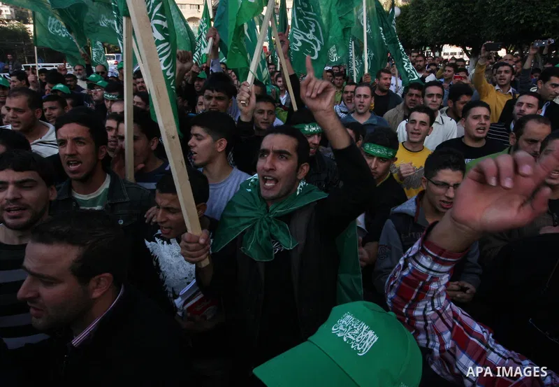 Palestinian supporters of the Islamist movement Hamas shout slogans during a demonstration in the West Bank city of Hebron, 21 November 2012, to show solidarity with Palestinians in the Gaza Strip. Palestinian militants...