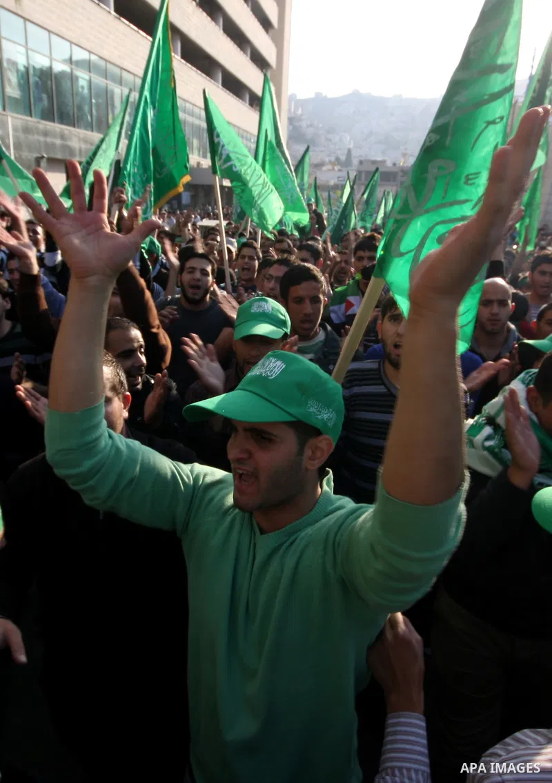 Palestinian supporters of the Islamist movement Hamas shout slogans during a demonstration in the West Bank city of Hebron, 21 November 2012, to show solidarity with Palestinians in the Gaza Strip. Palestinian militants...