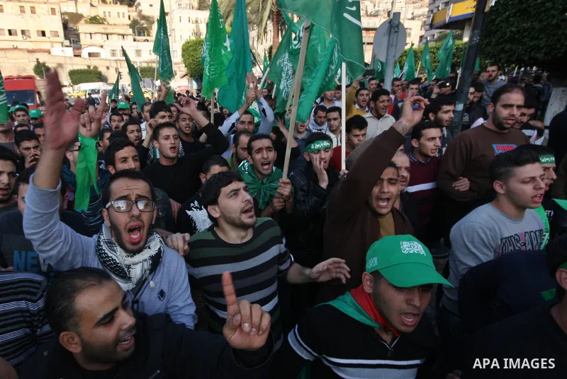 Palestinian supporters of the Islamist movement Hamas shout slogans during a demonstration in the West Bank city of Hebron, 21 November 2012, to show solidarity with Palestinians in the Gaza Strip. Palestinian militants...